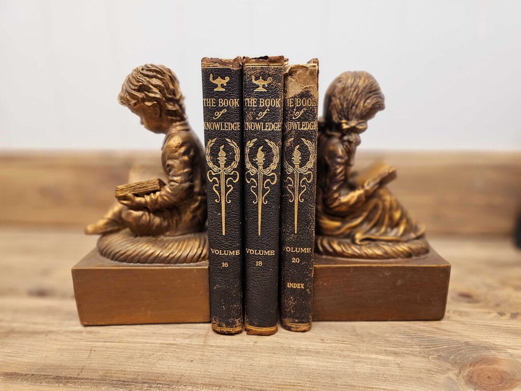 Vintage boy and girl reading bookends